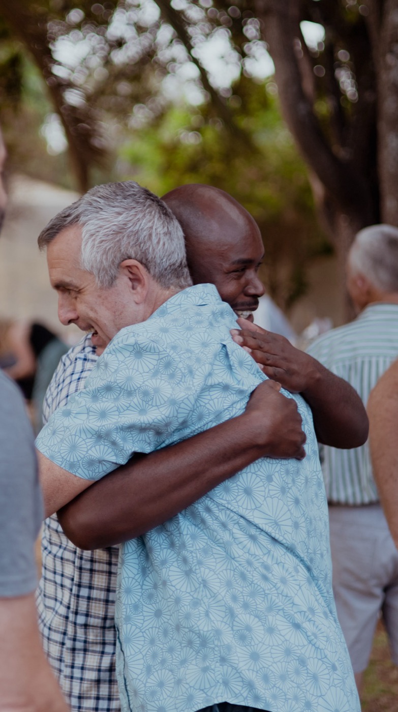 Church leaders embracing at a gathering in Zambia