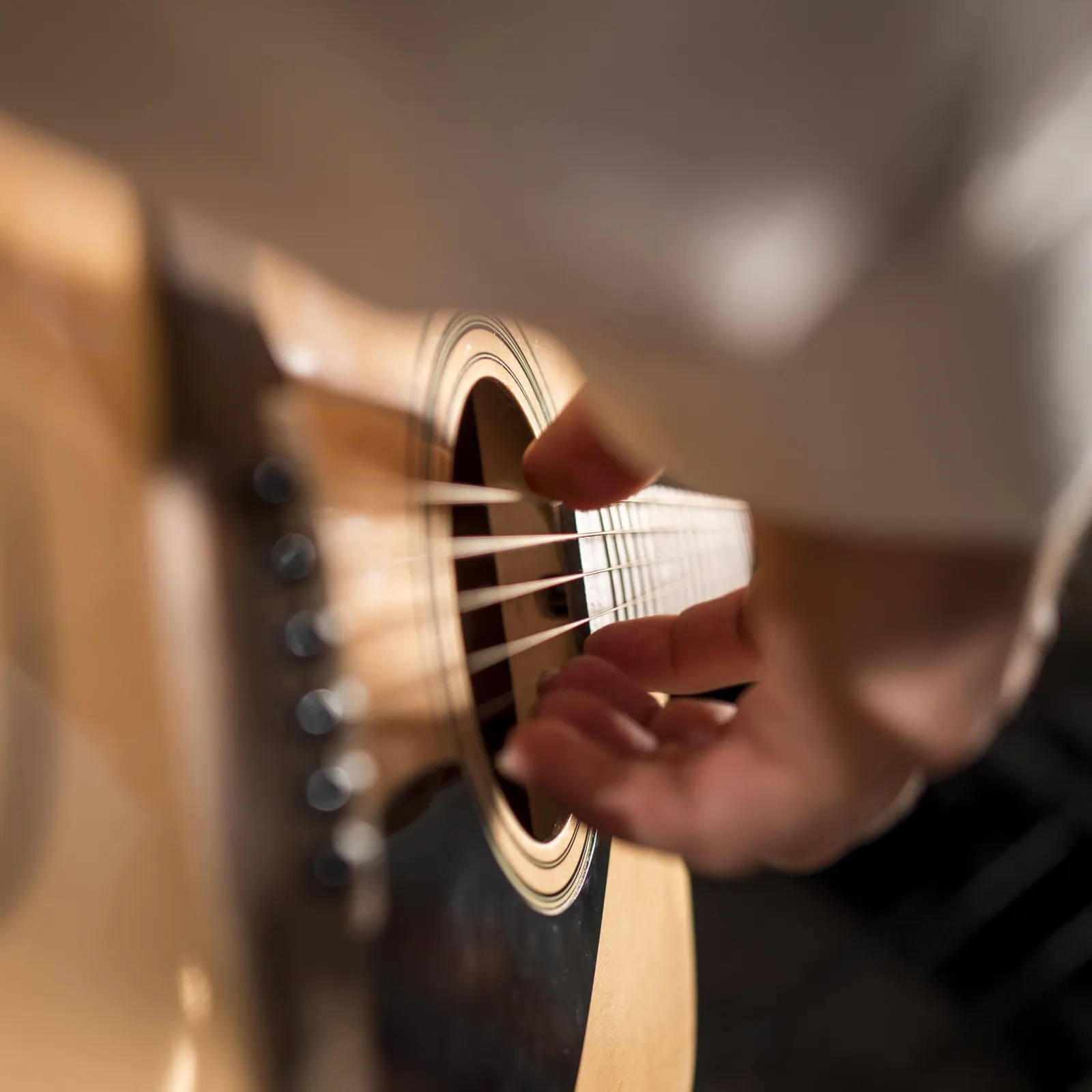Close-up of a musician playing an acoustic guitar